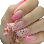unha em gel rosa com efeito degradÊ e detalhes adesivados